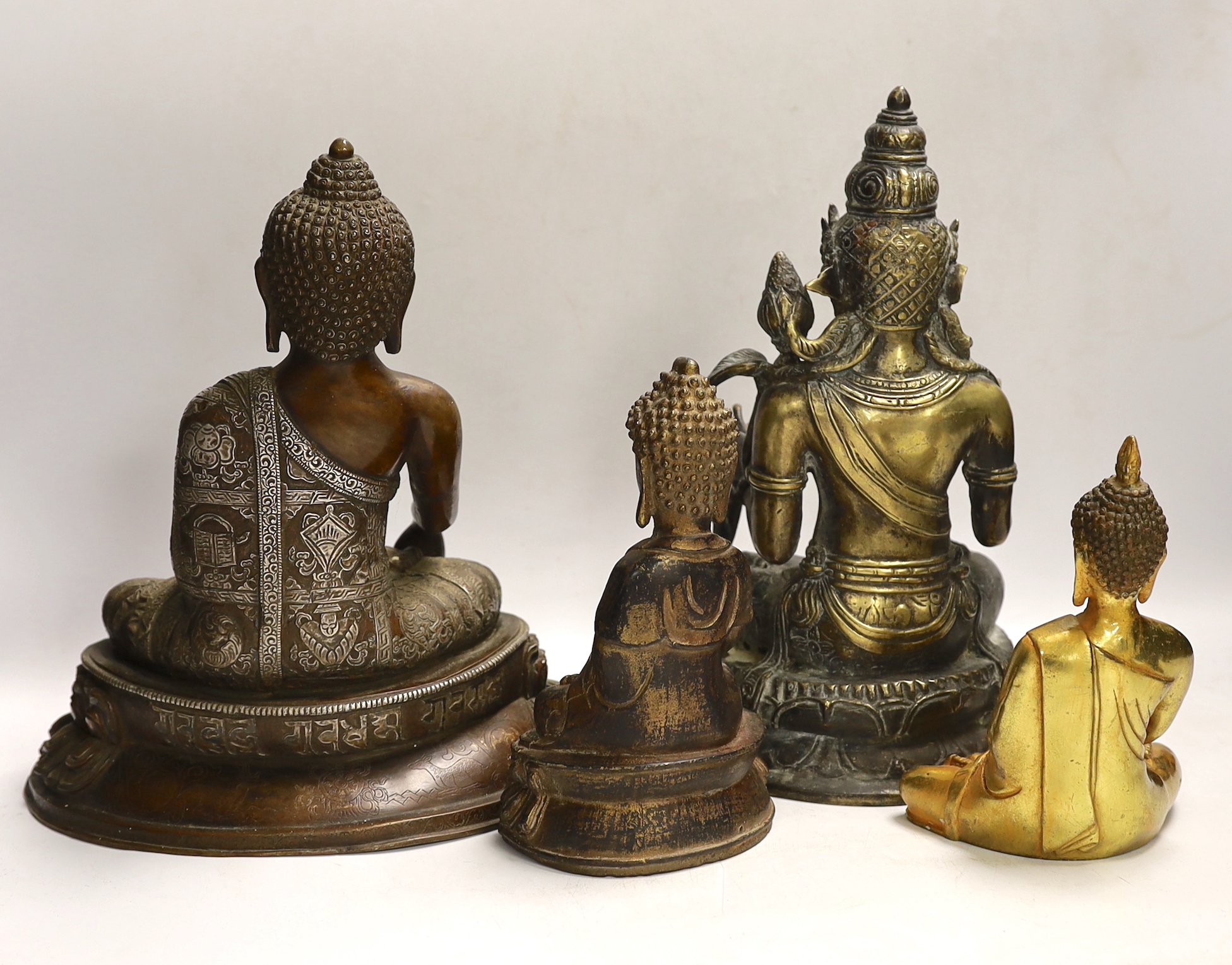 Four Thai and far-eastern bronze figures of the Buddha, tallest 28cm